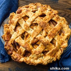 Timeless Flaky Apple Pie 10 Baked apple pie on wood table with blue napkins.