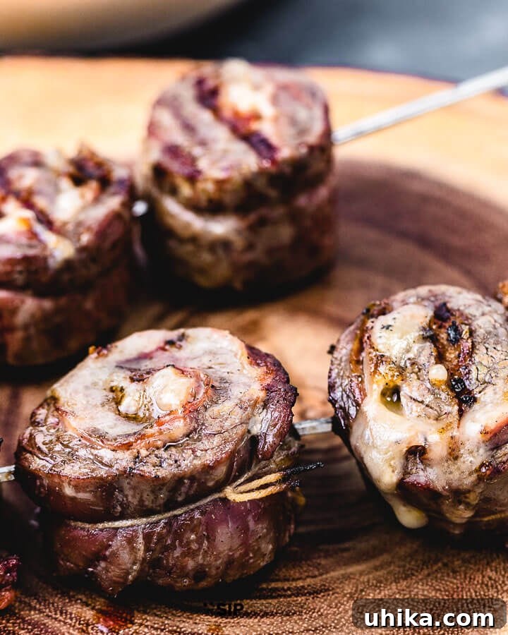Flank Steak Pinwheels with Prosciutto and Provolone – Easy Grilling Recipe Delicious grilled flank steak pinwheels arranged neatly on a wooden cutting board, ready to be served.
