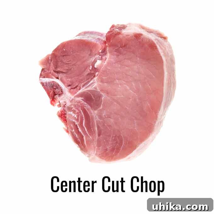 Effortless Crispy Oven Pork Chops 4 A raw center-cut pork chop on a white background, clearly showing the T-bone and distinct loin and tenderloin sections.