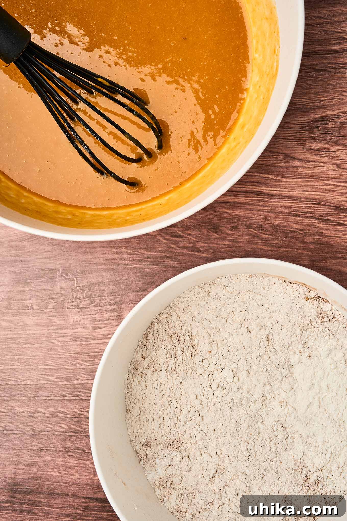 Cozy Pumpkin Spice Bites 4 Preparing pumpkin spice muffins with two mixing bowls, wet ingredients in one, dry in the other, ready to be combined.