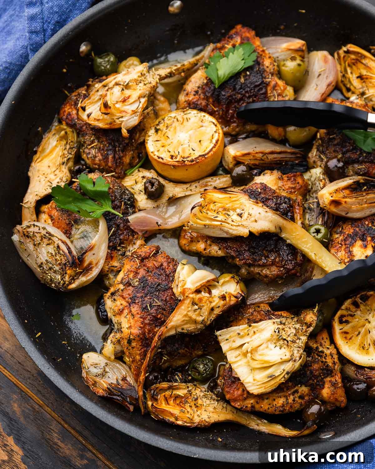 Rustic Provencal Roast Chicken 2 Large pan of chicken provencal topped with artichoke hearts and olives, ready to serve.