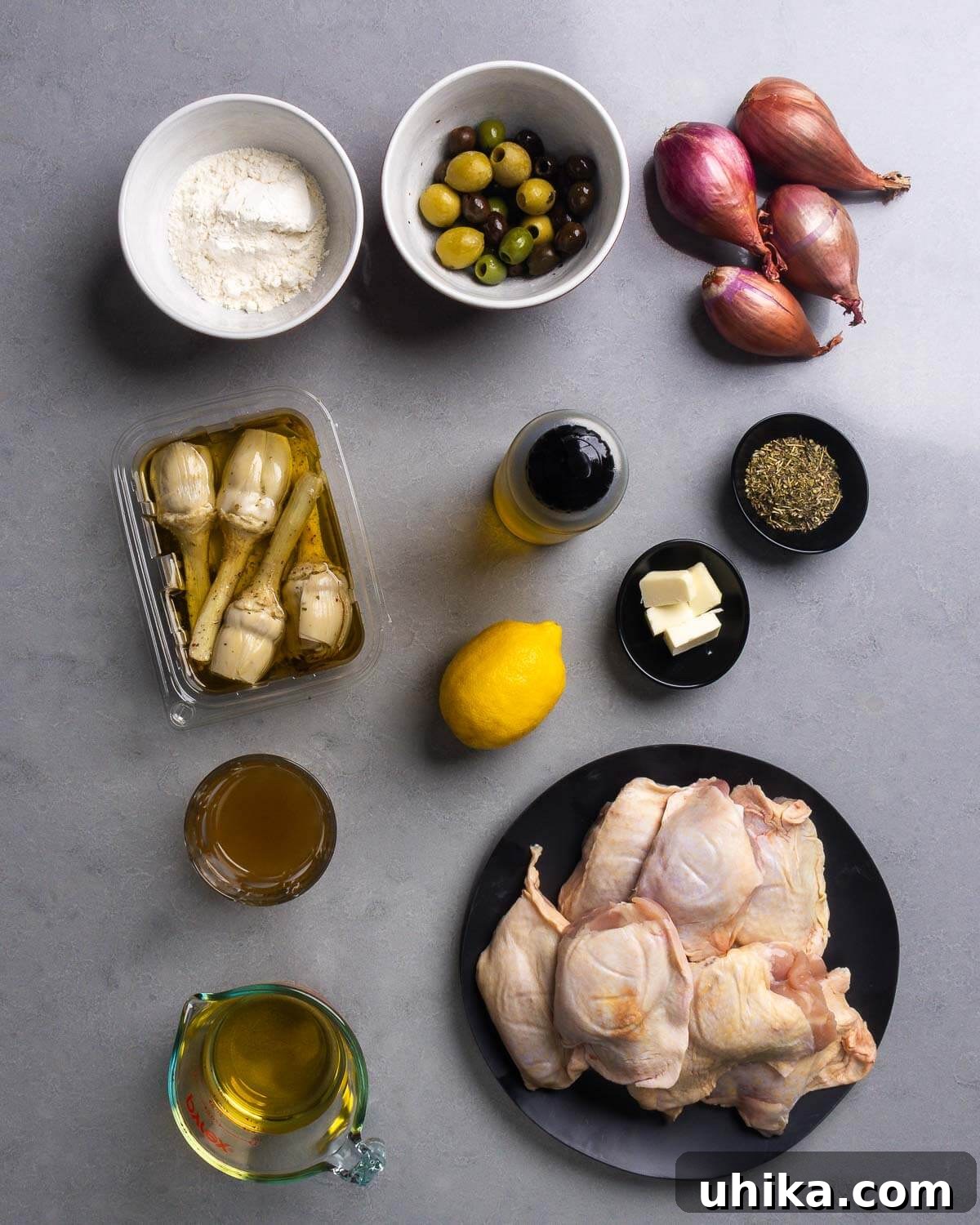 Rustic Provencal Roast Chicken 4 Ingredients shown: all-purpose flour, mixed olives, shallots, marinated artichoke hearts, olive oil, butter, lemon, herbes de provence, chicken stock, dry white wine or vermouth, and bone-in, skin-on chicken thighs.