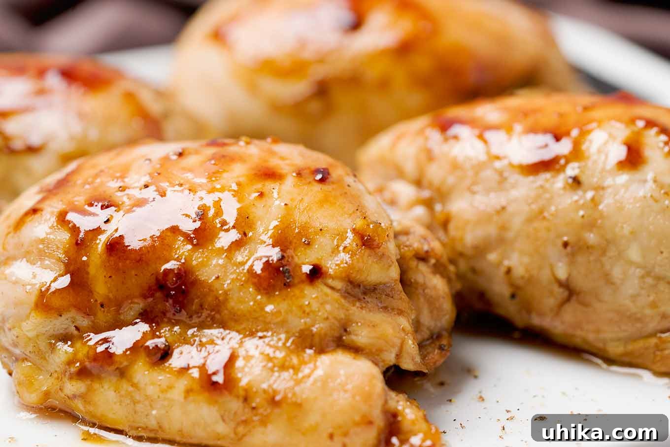 Succulent Oven-Roasted Boneless Chicken Thighs 4 A close-up of roasted boneless chicken thighs straight from the oven with the balsamic and honey glaze still bubbling.