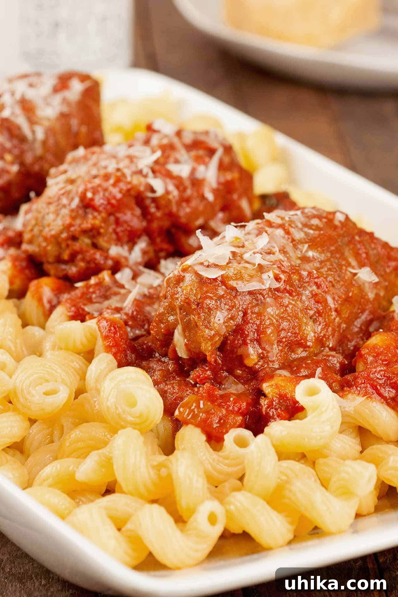 Effortless Italian Comfort Slow Cooker Braciole 4 Close up photo of slow-cooked Italian beef braciole served with tomato and red wine sauce over pasta.