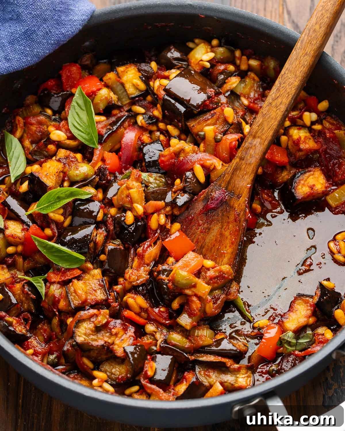 A vibrant bowl of Sicilian Eggplant Caponata, bursting with rich colors and textures, ready to be served.