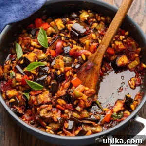 Eggplant caponata in black pan.
