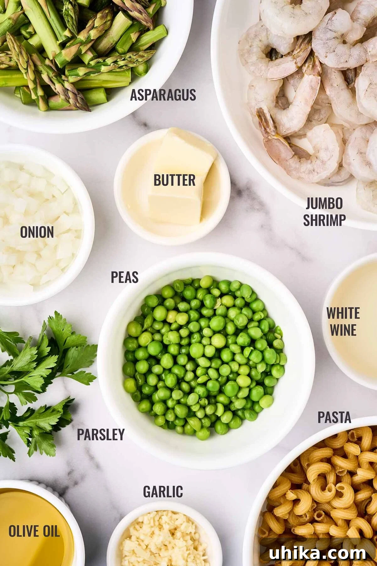 Vibrant Shrimp Primavera 3 A selection of ingredients for Shrimp Pasta Primavera, including jumbo shrimp, fresh asparagus, sweet peas, dry white wine, garlic, onion, and cavatappi pasta.