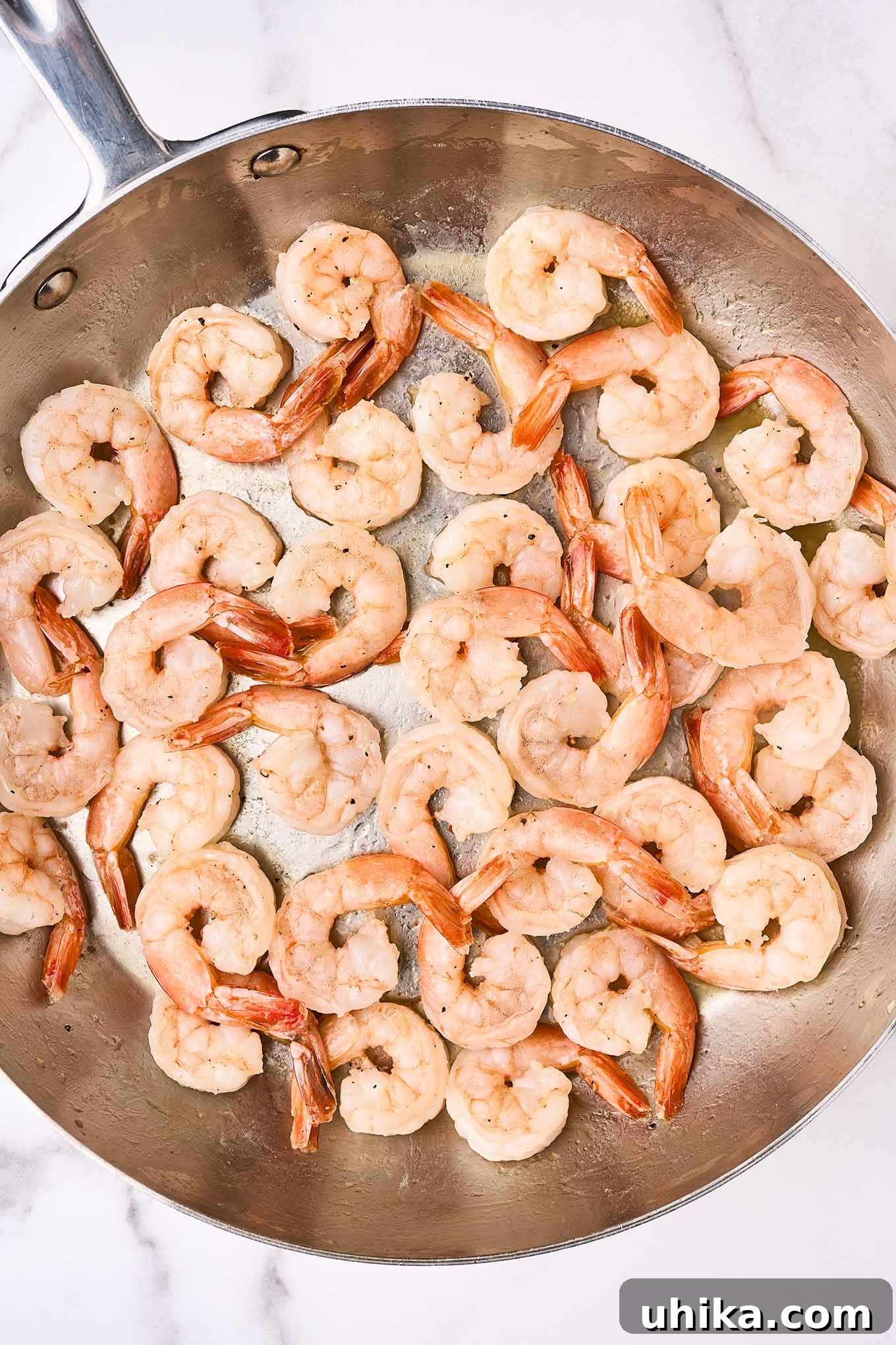 Vibrant Shrimp Primavera 6 Perfectly sautéed pink and opaque shrimp resting in a frying pan, ready to be incorporated into the pasta primavera.