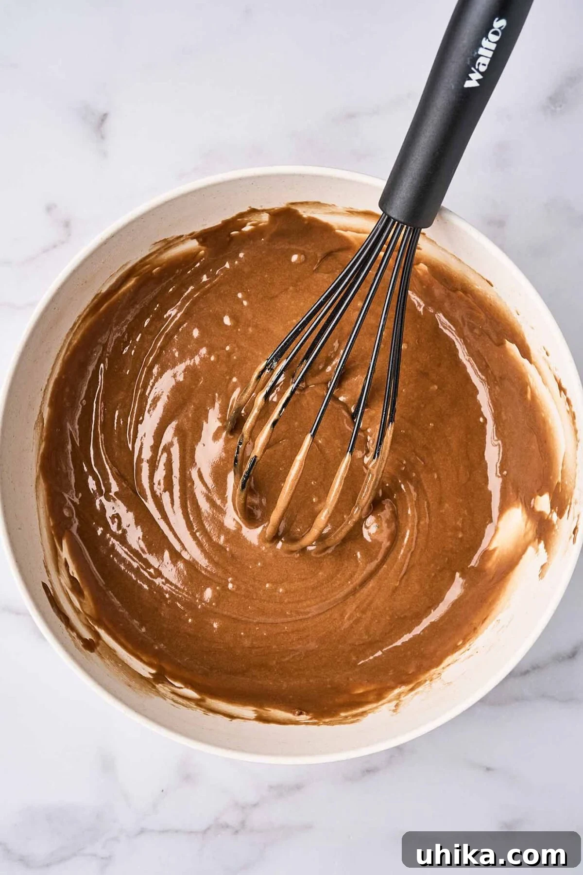 Double Chocolate Zucchini Loaf 5 A mixing bowl with the batter for chocolate zucchini bread (wet and dry ingredients combined) with a whisk.