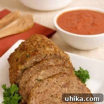 A round image of a Moroccan-Spiced Lamb Meatloaf slice with parsley and sauce, emphasizing the North African inspiration.