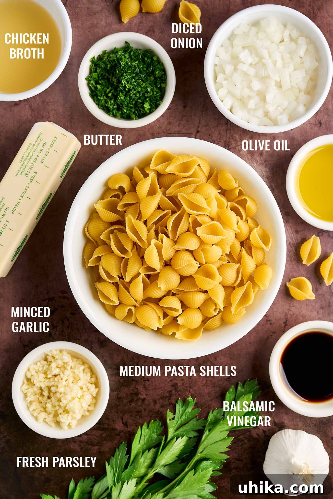 Buttery Garlic Shell Pasta 3 Ingredients for a garlic butter pasta side dish recipe, including pasta shells, butter, chicken broth, garlic, olive oil, onion, balsamic vinegar and parsley.