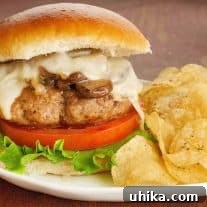 A pan-seared turkey burger topped with sautéed mushrooms and onions and melted muenster cheese.