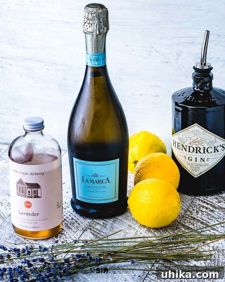 Lavender French 75 Ingredients Spread Ingredients for Lavender French 75 laid out: bottle of Prosecco, gin, lavender simple syrup, fresh lemons, and a bunch of fresh lavender.