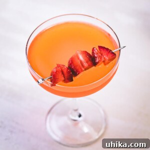 Strawberry lemonade vodka in glass with strawberry garnish.