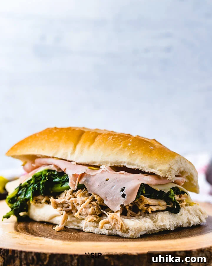 Italian pulled pork sandwich with mortadella on wooden board. Gourmet pulled pork sandwich with mortadella and provolone.
