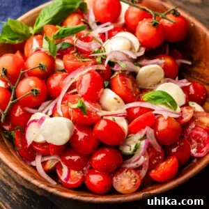 Tomato mozzarella salad in wood bowl.