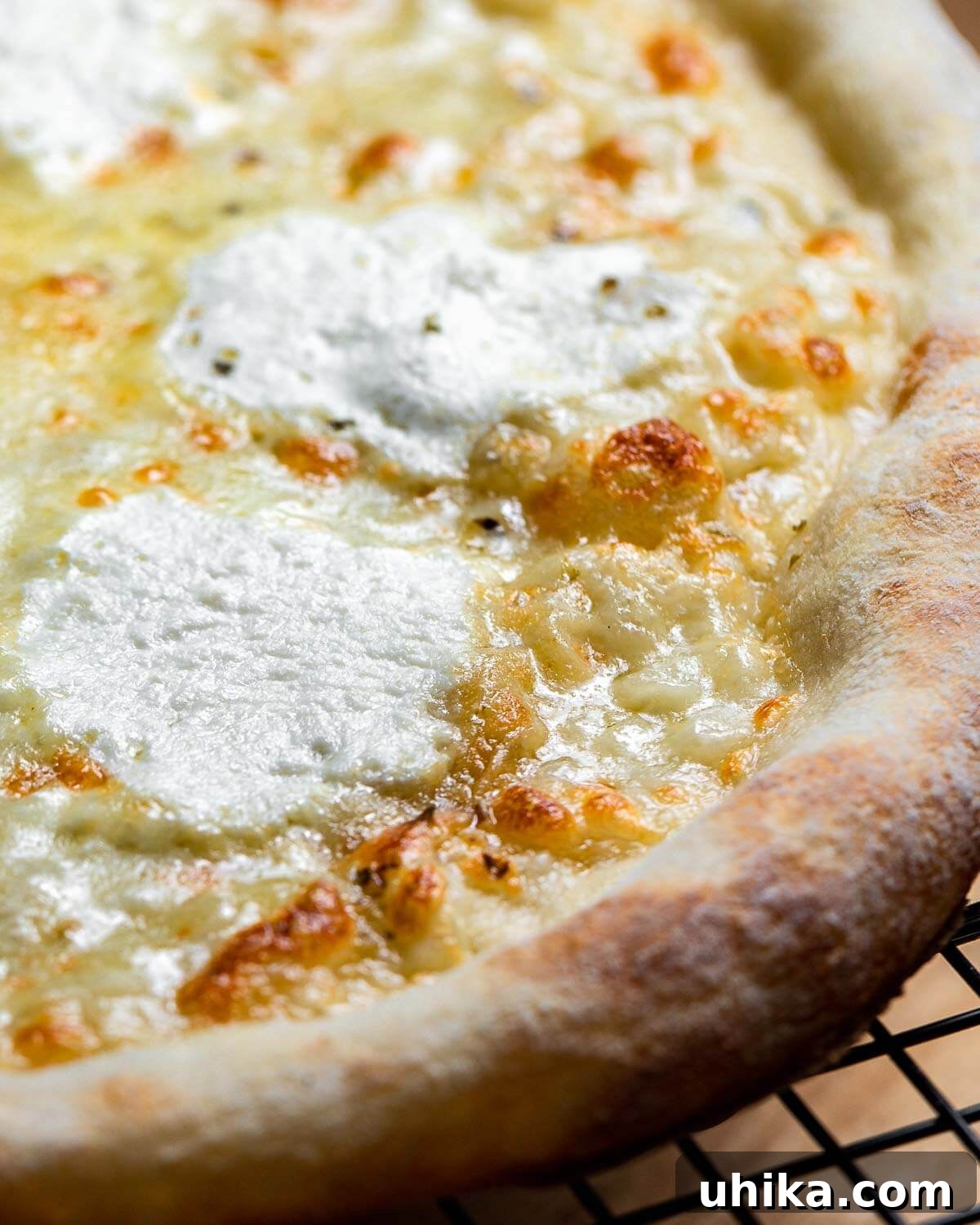 Creamy Garlic New York White Pizza 7 A freshly baked New York white pizza cooling on a wire rack, steam gently rising, showcasing its perfect bake.