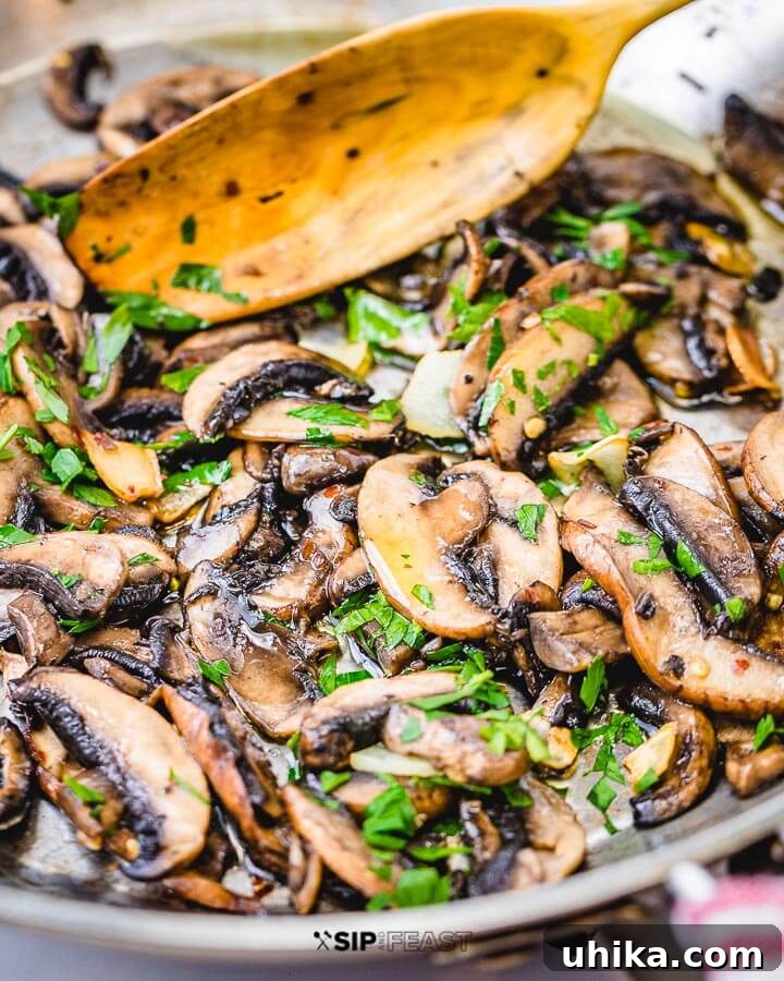 Closeup shot of garlic sauteed mushrooms in pan.