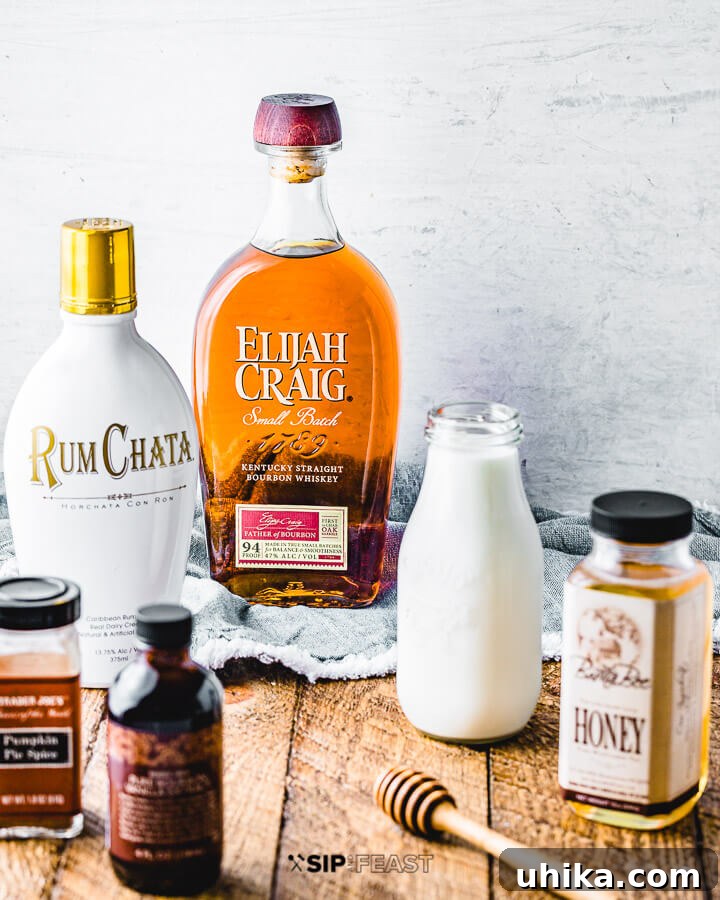 Pumpkin Spice Bourbon Velvet Punch 4 Ingredients shown: Rumchata, bourbon, milk, honey, pumpkin spice, and vanilla extract.