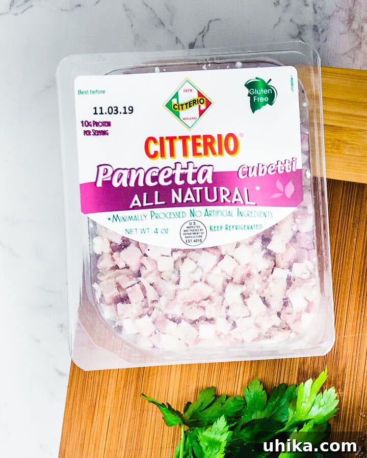 Package of Citterio diced pancetta resting on a wooden cutting board, ready for cooking.