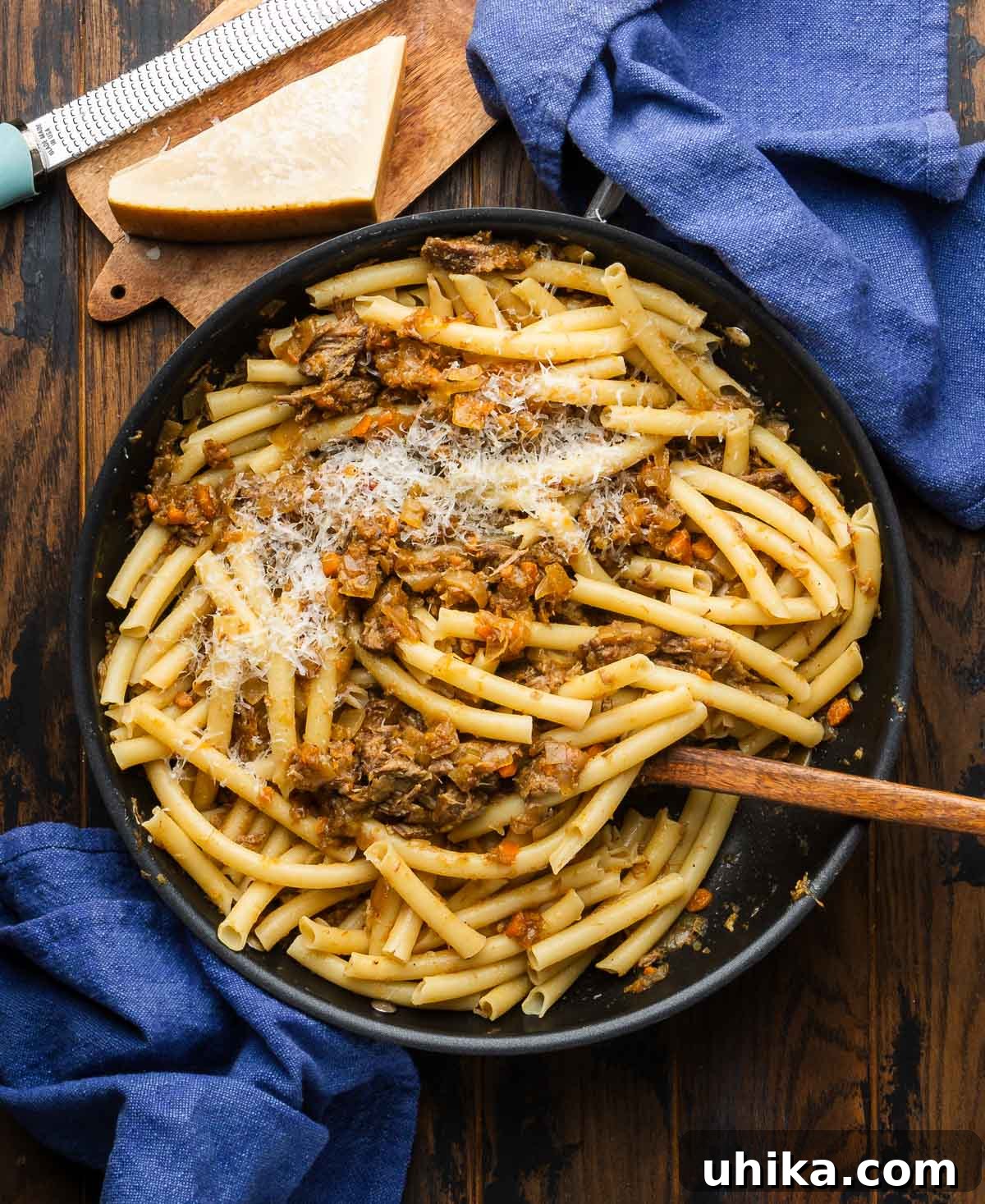 Hearty Genovese Slow-Cooked Pasta 7 Large black pan with pasta alla Genovese with hand broken long ziti.