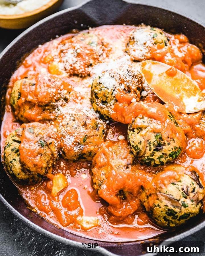Hearty Mushroom Meatballs with Rich Marinara Sauce Mushroom meatballs and sauce in cast iron pan.