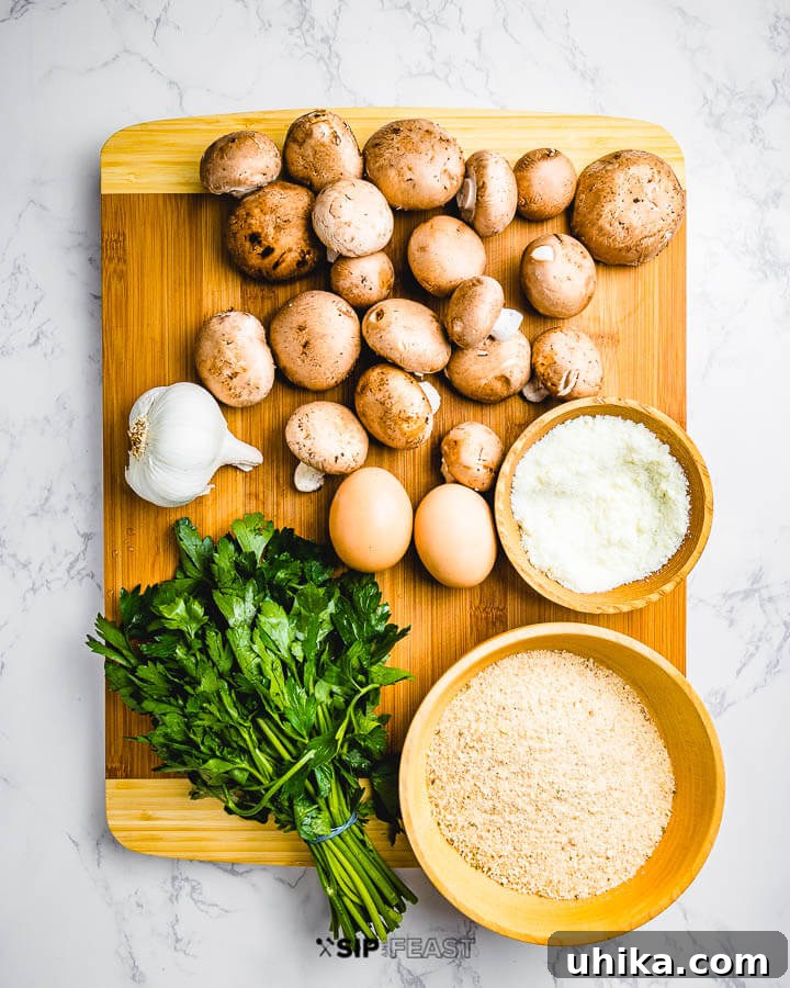 Essential Ingredients for Flavorful Mushroom Meatballs Ingredients shown: baby Bella mushrooms, garlic, Pecorino Romano cheese, parsley, and breadcrumbs.