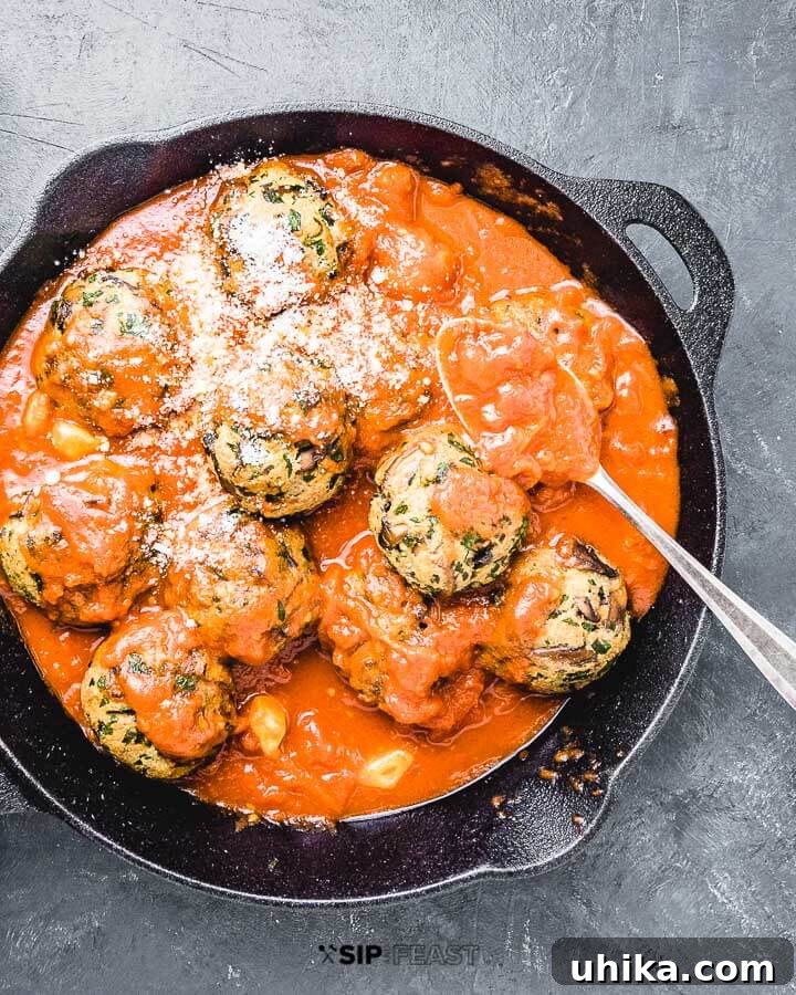 Mushroom Meatballs Ready to Serve in Cast Iron Mushroom meatballs in cast iron pan on blue background.