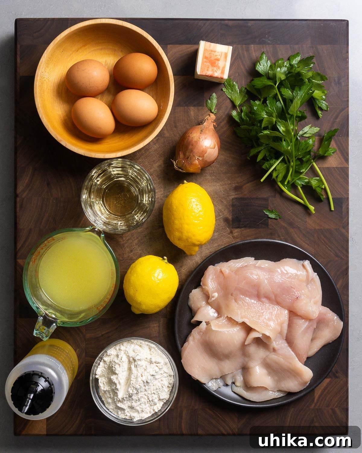 Golden Chicken Francese with Zesty Lemon Butter 3 Ingredients shown: eggs, butter, shallot, parsley, white wine, chicken stock, lemons, olive oil, flour, and chicken cutlets.