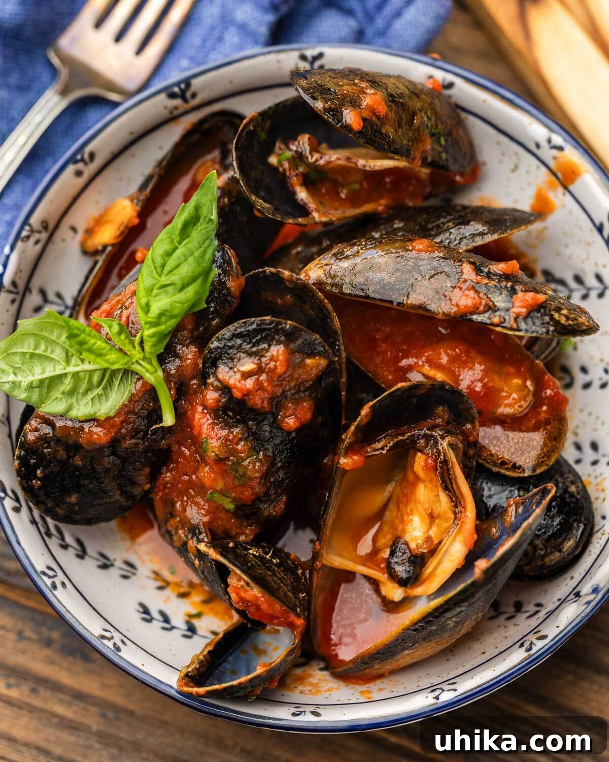 Marinara Mussels in Minutes: Easy Seafood Appetizer 2 A glistening bowl of Mussels Marinara, garnished with fresh basil, ready to be enjoyed.
