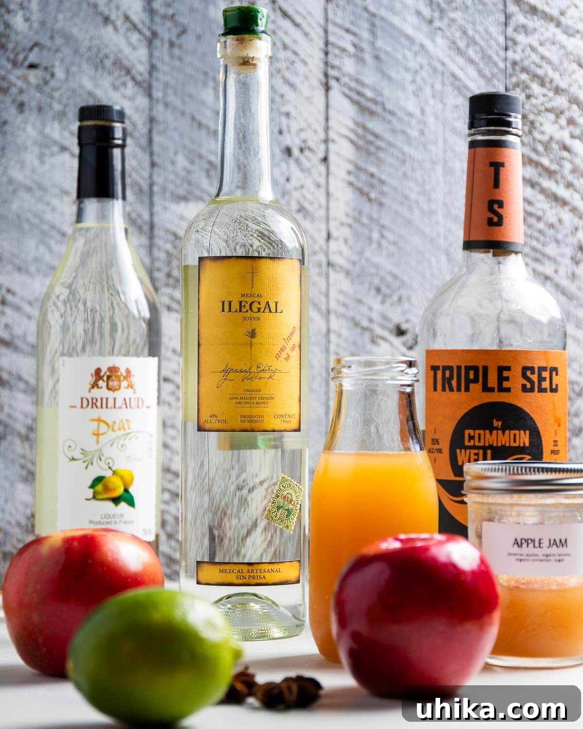 Ingredients shown: pear liqueur, mezcal, triple sec, apple cider, apple jam, apples, and lime.