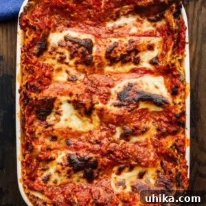 Lasagna in white baking dish.