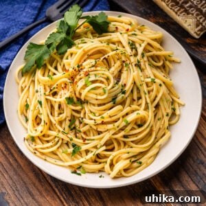 Aromatic Garlic and Olive Oil Linguine 8 Linguine aglio e olio in white plate with parsley garnish.