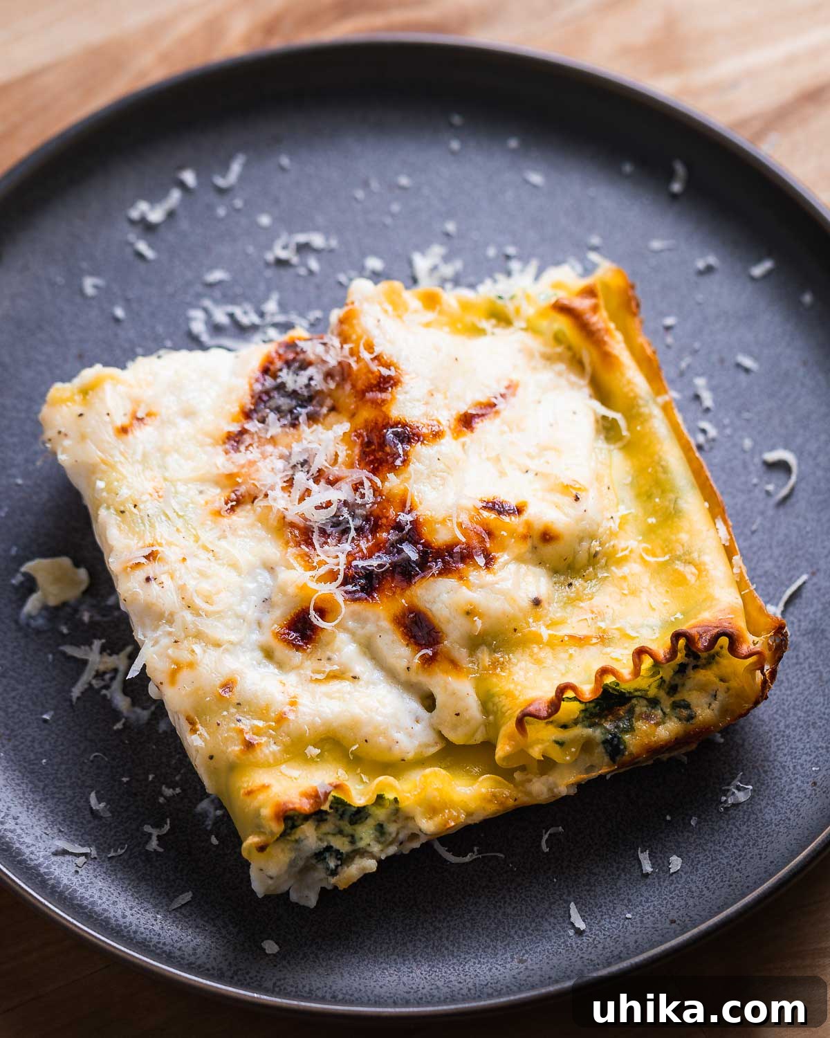 Creamy Spinach Lasagna Rolls 3 Grey plate with two pieces of spinach lasagna rolls, garnished and ready to eat.