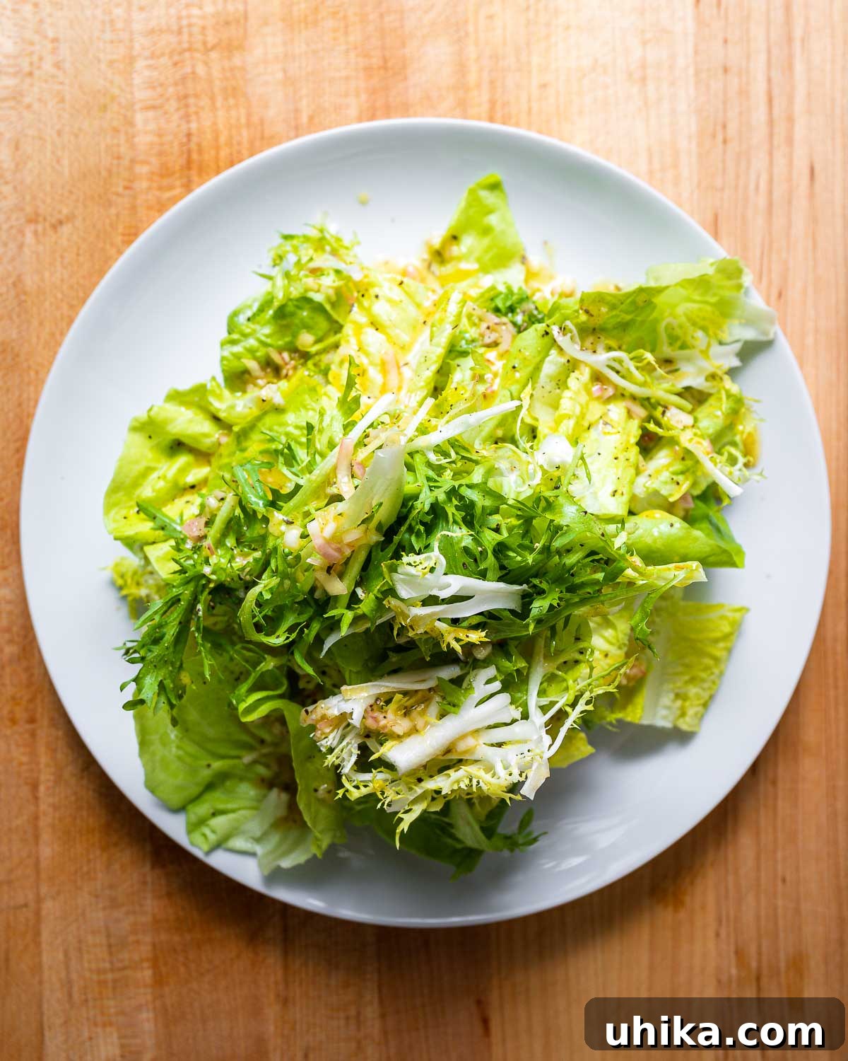Via Carota House Salad 7 Overhead shot of white plate with 3 types of lettuce.
