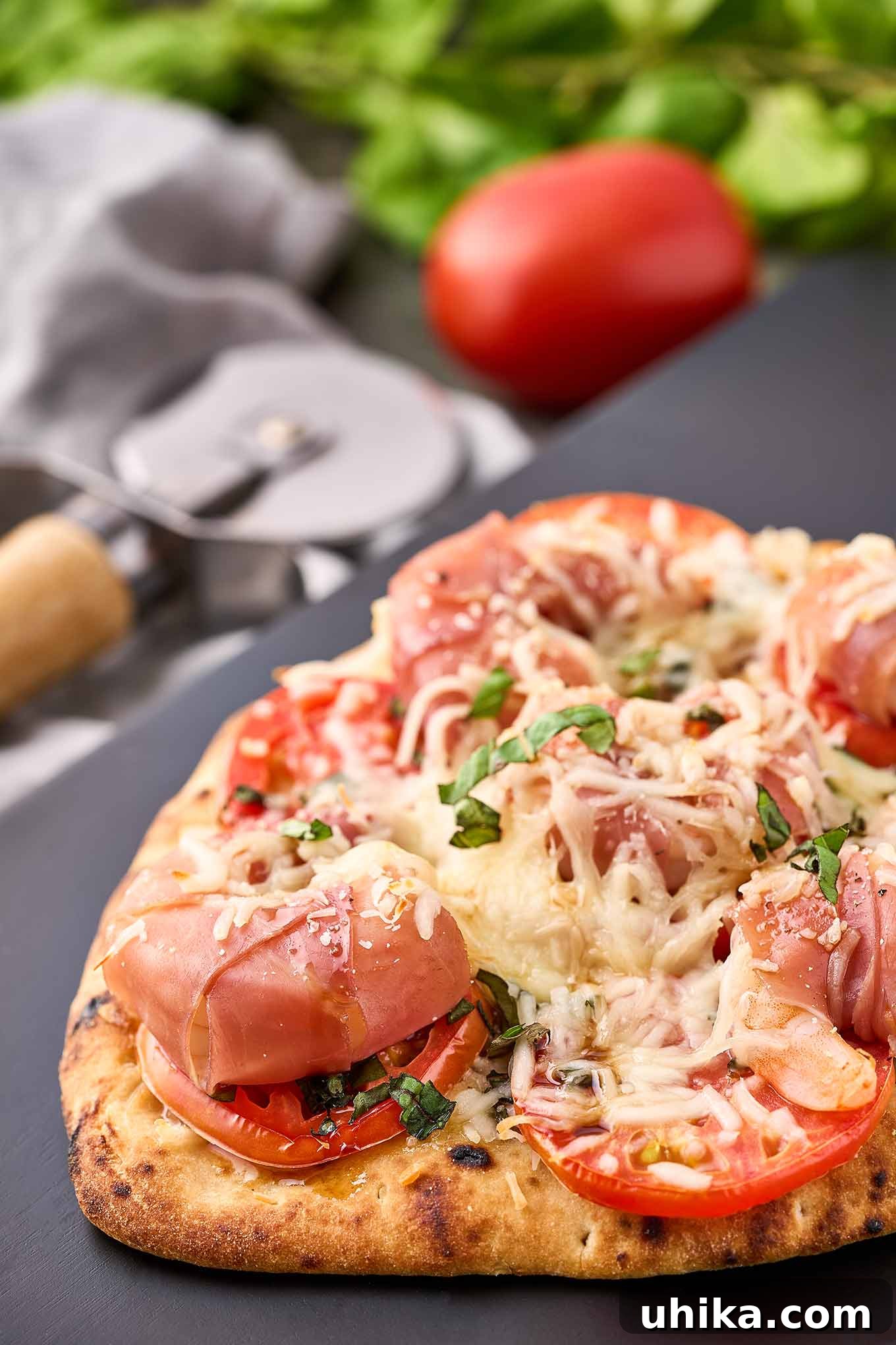 Prosciutto-Wrapped Shrimp Naan Pizza 6 Crispy naan pizza topped with prosciutto-wrapped jumbo shrimp, sliced tomato, fresh basil, and melted mozzarella.