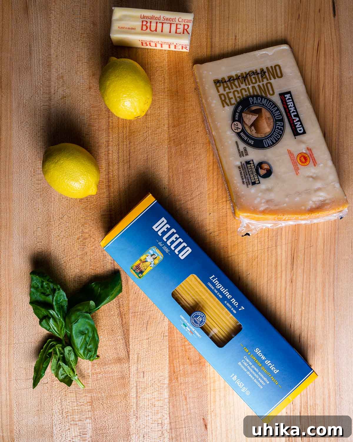Sunshine Lemon Linguine 3 Ingredients shown: butter, fresh lemons, finely grated parmesan cheese, fresh basil leaves, and a box of linguine pasta.