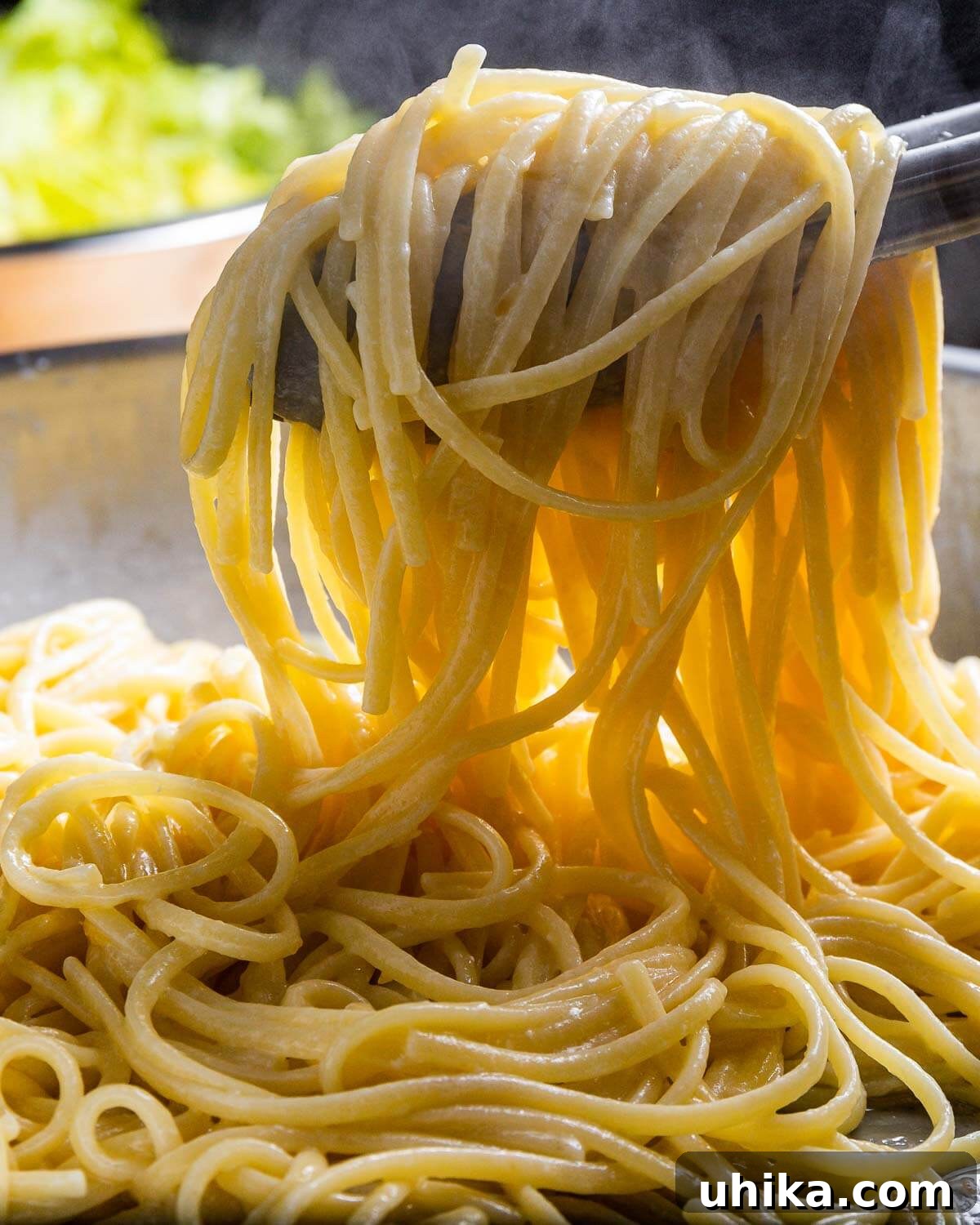 Sunshine Lemon Linguine 7 Tongs holding creamy linguine al limone with cheese and herbs.