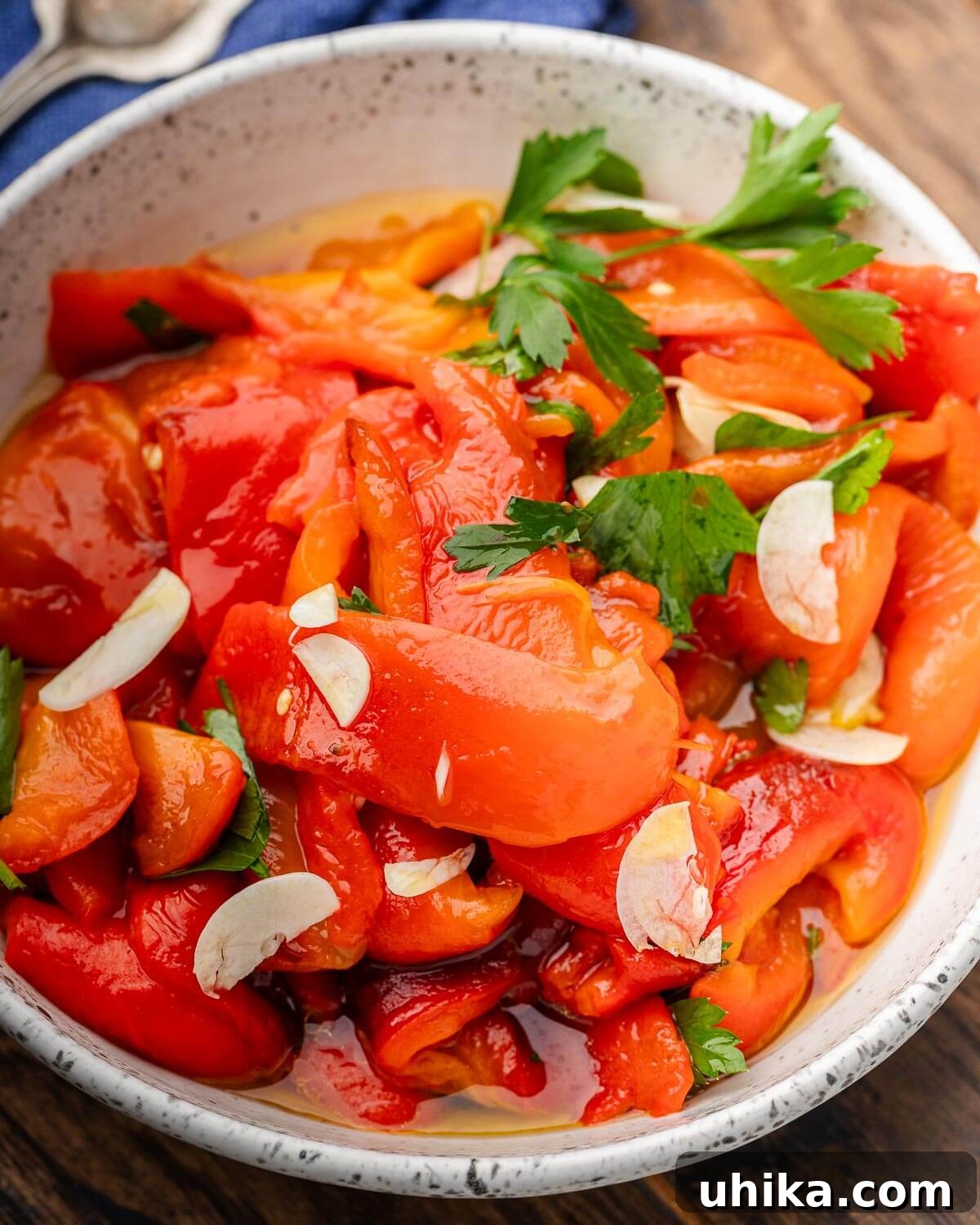 Perfectly Roasted Italian Red Peppers 2 Large white bowl with Italian roasted red peppers with parsley garnish.