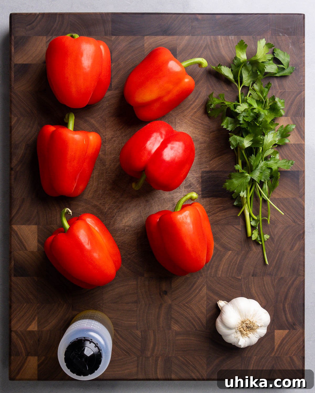 Perfectly Roasted Italian Red Peppers 3 Ingredients shown: red bell peppers, parsley, olive oil, and garlic.