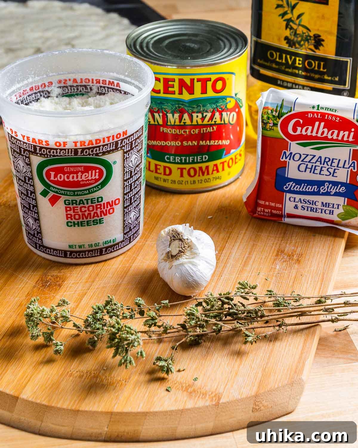 Heirloom Pan Pizza 3 Ingredients shown: Locatelli Pecorino Romano, San Marzano tomatoes, mozzarella cheese, olive oil, garlic, and Sicilian oregano.