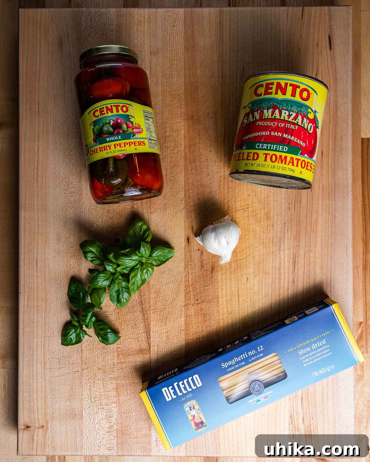 Fiery Tomato Spaghetti 3 Ingredients shown: cherry peppers, San Marzano plum tomatoes, basil, garlic, spaghetti.