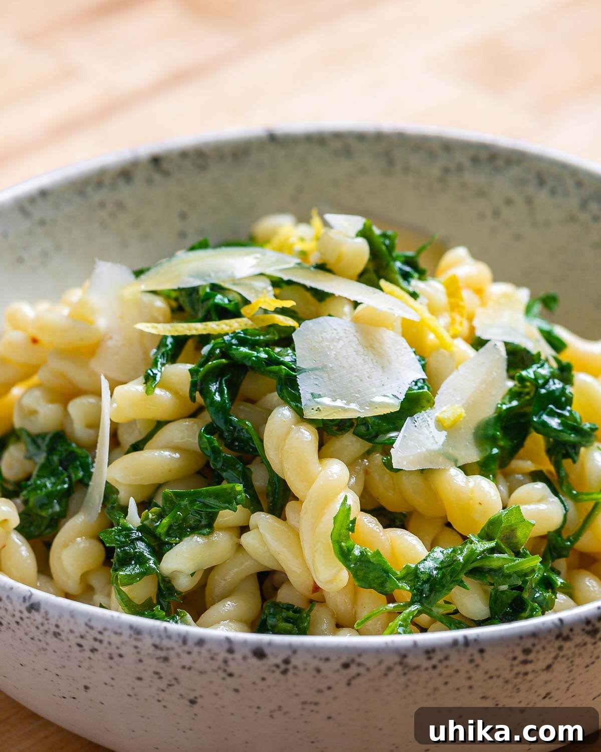 Bright Lemon Arugula Pasta 2 Bright lemon arugula pasta served in a pristine white bowl, garnished with fresh parsley and lemon zest.