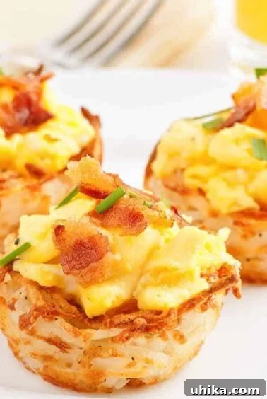 Crafting Memorable Brunch Spreads 8 A serving plate with three hash brown potato cups filled with scrambled eggs topped with bacon and garnished with chives.