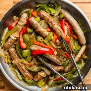 Quick 5 Ingredient Sausage and Peppers 8 Sausage and peppers in pan with tongs.
