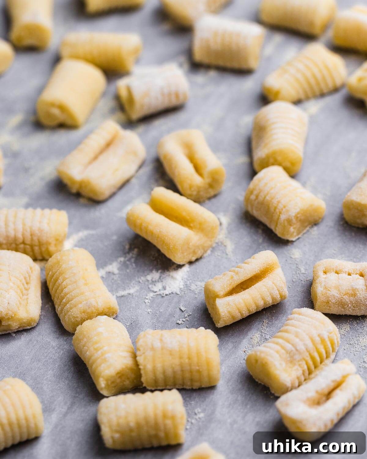 Perfect Potato Pillows 2 Fresh made potato gnocchi on parchment paper lined baking sheet.