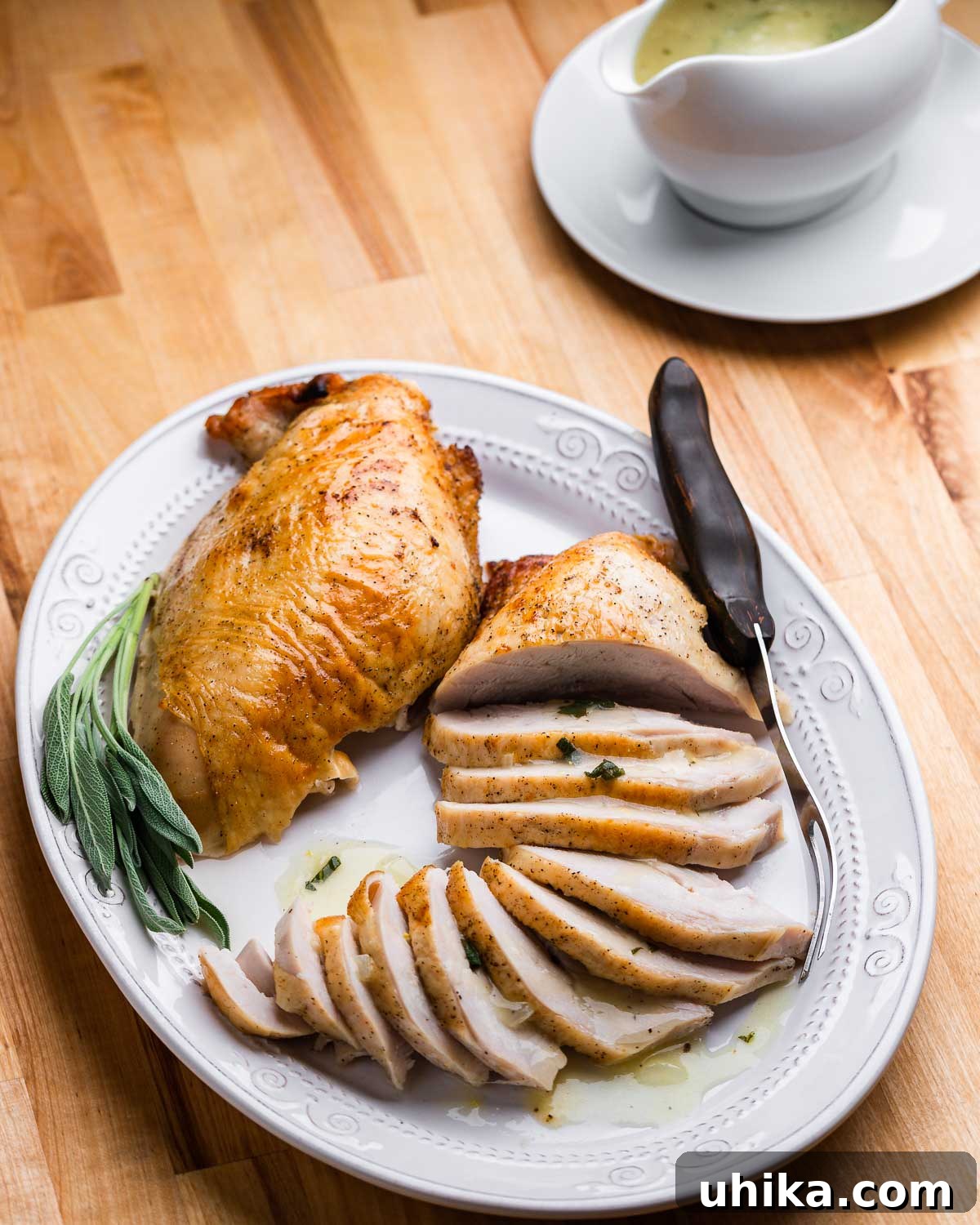 Succulent Dry Brined Turkey Breast 2 Platter with one carved and one uncarved turkey breast and carving fork.