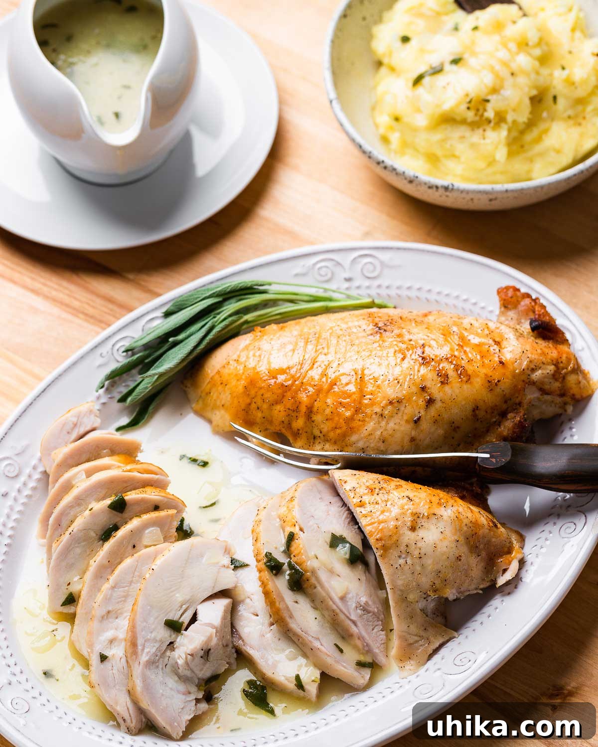 Succulent Dry Brined Turkey Breast 8 Platter with carved turkey breast, bowl of mashed potatoes, and gravy boat.