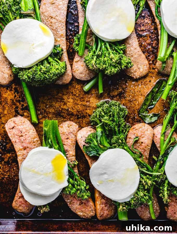 One-Pan Roasted Sausage & Broccolini 5 The Roasted Broccolini Sheet Pan Dinner with sausages and broccolini, now topped with slices of fresh mozzarella cheese, ready for a quick broil.