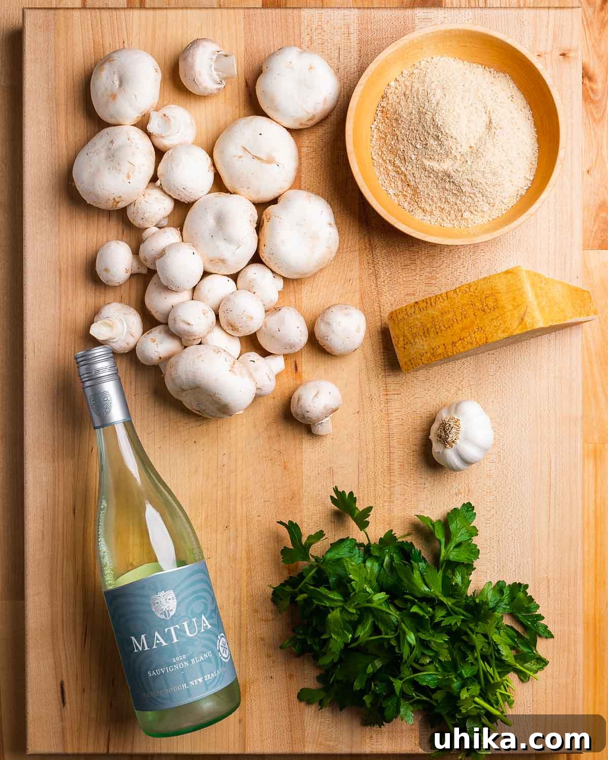 Parmesan & Herb Stuffed Mushrooms 2 Ingredients shown: Loose mushrooms, breadcrumbs, white wine, parsley, garlic, and parmesan cheese.